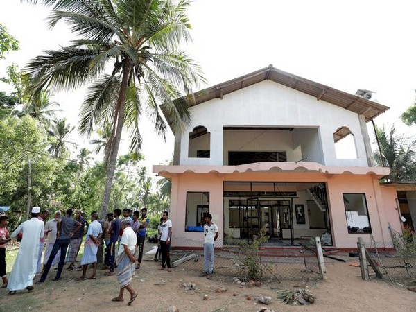 Muslim men gather outside the Abbraar Masjid mosque after a mob attack in Kiniyama, Sri Lanka on Sunday (photo courtesy: Reuters)