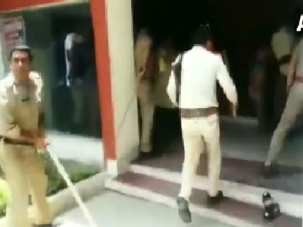 Uttar Pradesh police officals beat transgenders with lathi in Meerut on Monday. Photo/ANI