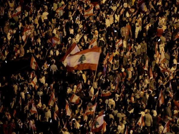 Demonstrators hold Lebanese flags during anti-government protests in Beirut. (File photo)