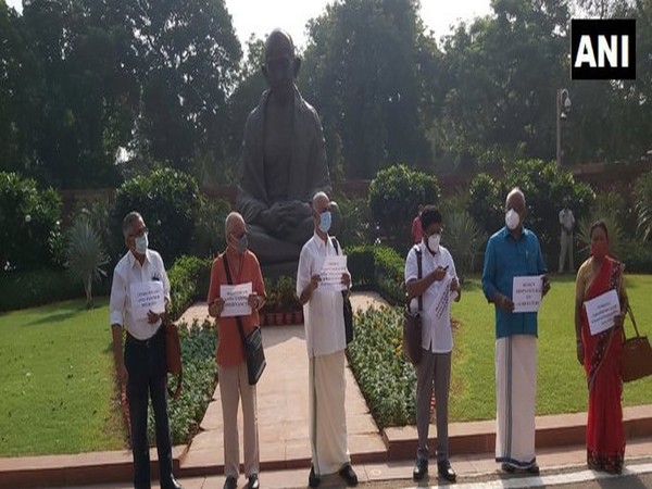 Left MPs protest in front of Mahatma Gandhi statue at Parliament on Tuesday. [Photo/ANI]