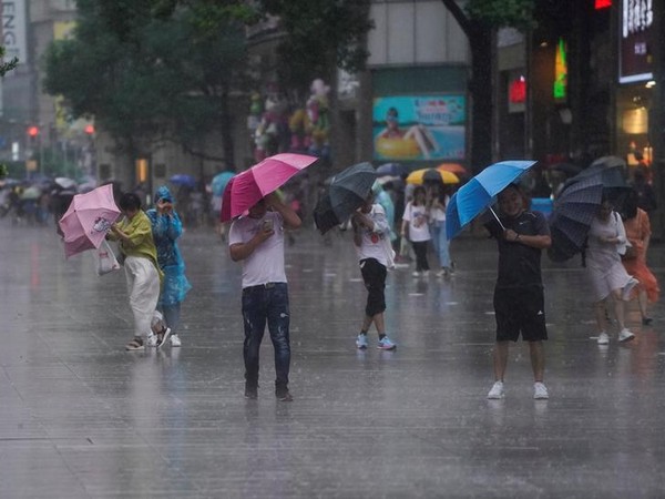 People walking through the rain as typhoon Lekima approached Shanghai, China on Aug 10 (Photo/Reuters)