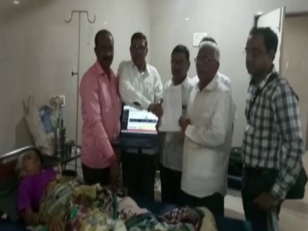 Bank officials awarding loan approval certificate to the family