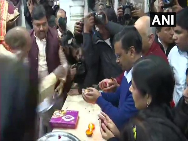 AAP chief Arvind Kejriwal, his wife Sunita Kejriwal and party leader Manish Sisodia offer prayers at Hanuman Temple in Connaught Place.