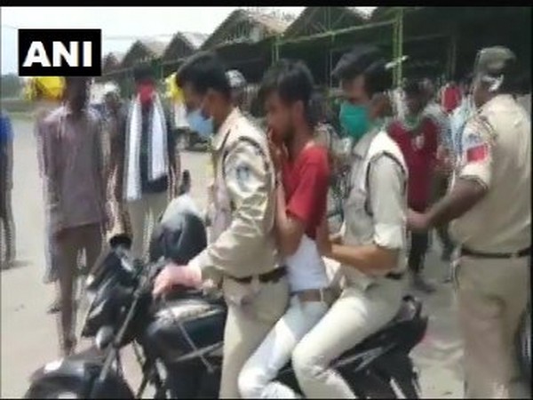 A man accused of stealing being taken by police in Madhya Pradesh's Khargone