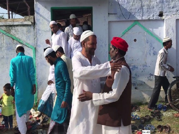 People wishing each other after offering Namaz at a mosque in Ayodhya, Uttar Pradesh on August 12. Photo/ANI