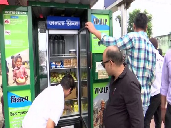 People utilising the public fridge installed in Dehradun market in Uttarakhand. Photo/ANI