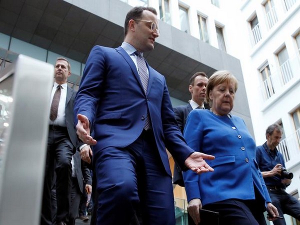 German Chancellor Angela Merkel and Health Minister Jens Spahn leave after a news conference on coronavirus in Berlin