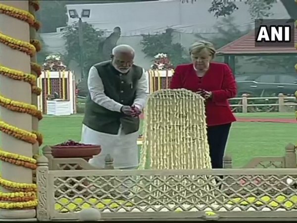 PM Narendra Modi and German Chancellor Angela Merkel at Gandhi Smriti in New Delhi on Friday