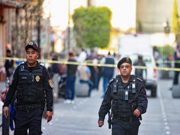 Police officers at the crime scene in Mexico city where four people were killed on Saturday