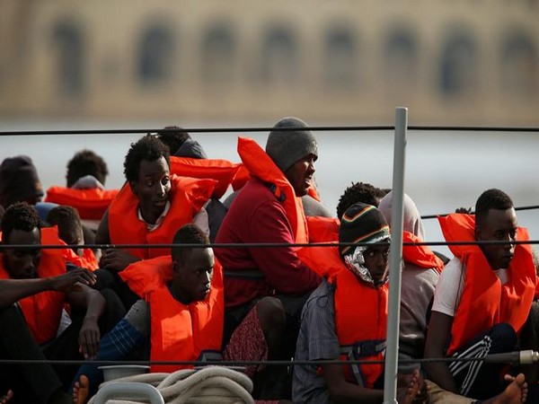 Migrants sit on an Armed Forces of Malta patrol boat before disembarking at its base in Marsamxett Harbour, Malta on Saturday