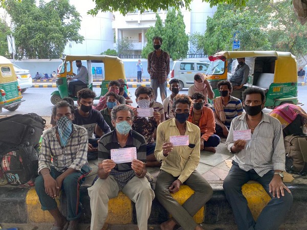 Migrant workers in Delhi showing their train tickets