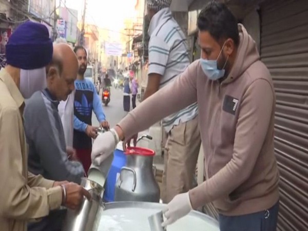 Milk vendor in Amritsar selling milk. Photo/ANI