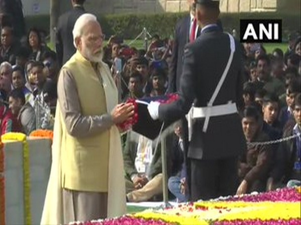 Prime Minister Narendra Modi offers floral tributes to Mahatma Gandhi at Raj Ghat in New Delhi.