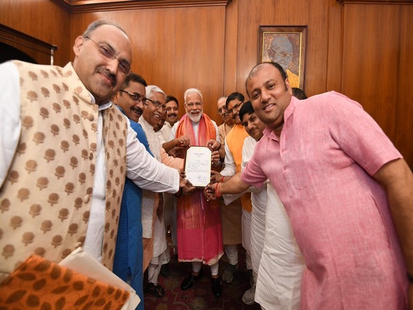 Prime Minister Narendra Modi receiving his winning certificate from his party colleagues!