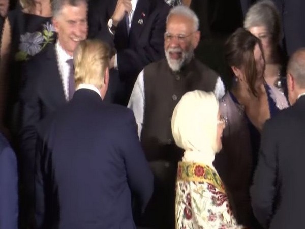 Prime Minister Narendra Modi exchanging pleasantries with US President Donald Trump during photo session at G-20 Summit at Osaka, Japan on Friday. Photo/ANI