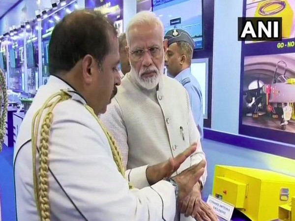 PM Modi with IAF Chief RKS Bhadauria at the exhibition on Wednesday in New Delhi. Photo/ANI