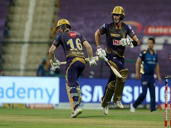 KKR's Pat Cummins and Eoin Morgan  takes a run during the match