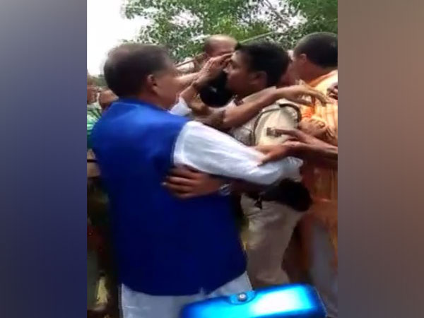 JD (U) MP from Jhanjharpur constituency, RP Mandal being protected by police in a villager in Bihar.