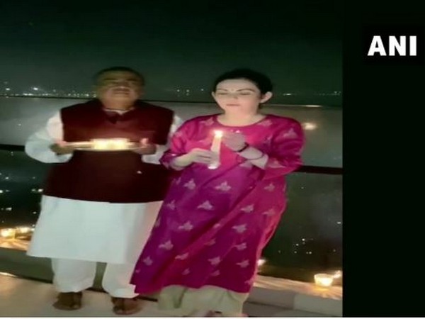 Mukesh Ambani with his wife Nita Ambani lights candle in Mumbai on Sunday. Photo/ANI