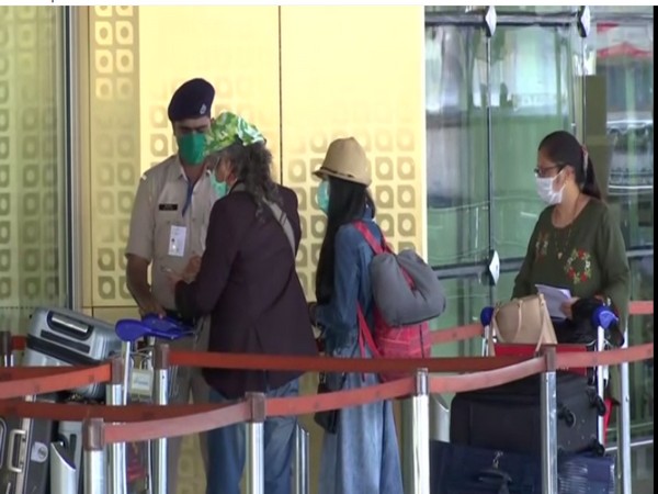 Passengers wearing mask checking into the Mumbai Airport on Wednesday. Photo/ANI