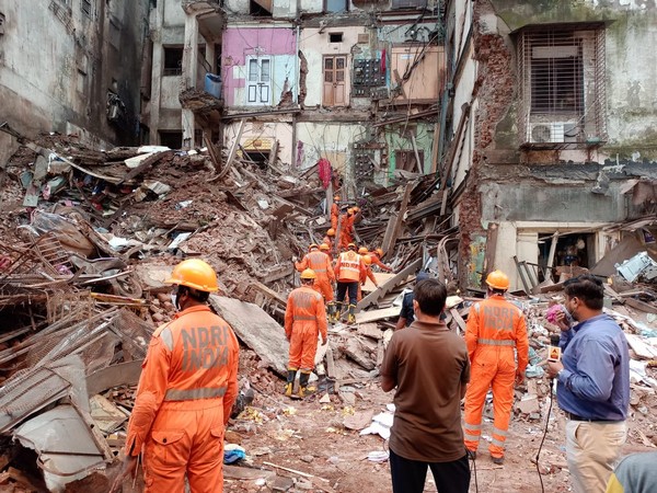 Debris being cleared from a site in Mumbai's Fort where a portion of a building collapsed on Thursday. (Photo/ANI)