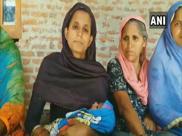 Family names their newborn son 'Narendra Modi'. Menaj Begum, mother with the baby