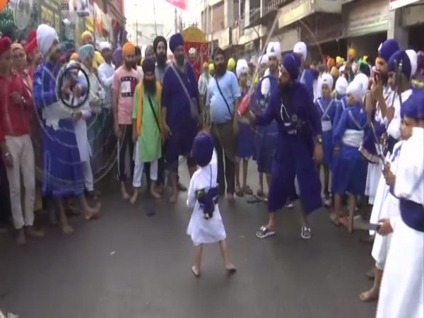 men performing various stunts including children in the procession outside in Amritsar in Punjab on Saturday. Photo/ANI