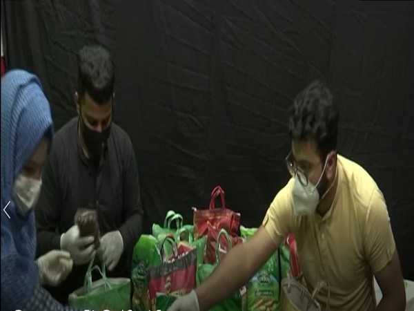 Youngsters packing food kit to distribute among poor in Srinagar. (Photo/ANI)