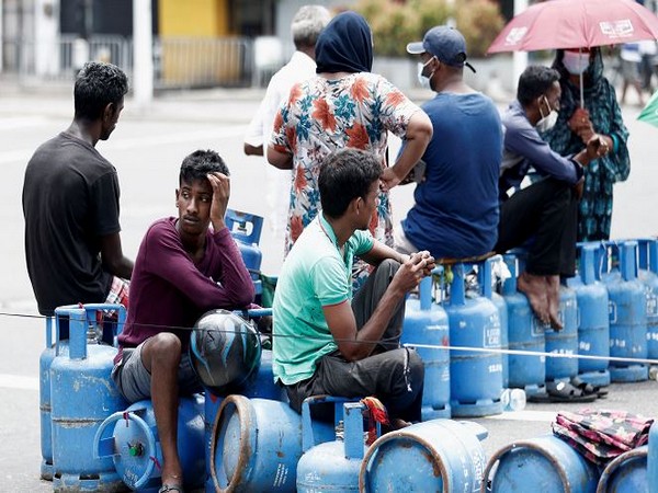 People block a main road as they wait for the gas trucks to arrive at the station to distribute for them (Photo Credit: Reuters)