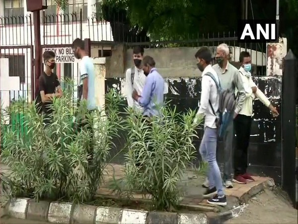 Candidates outside an exam centre in New Delhi on Sunday. (Photo/ANI)