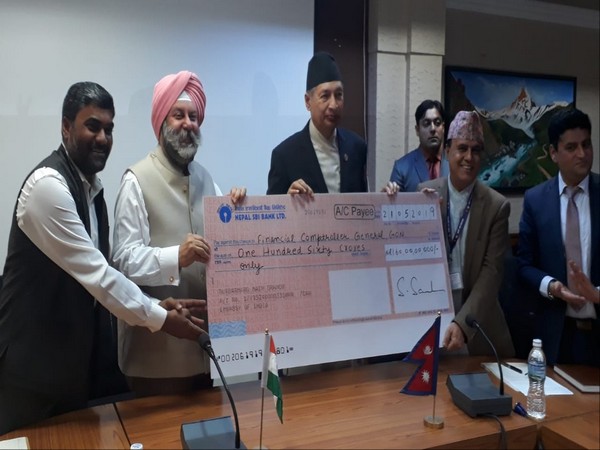 Ambassador of India to Nepal, Manjeev Singh Puri, handing over the cheque for housing reconstruction in areas devastated by the 2015 earthquake 