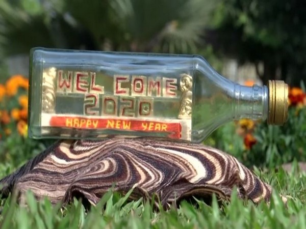 The miniature art 'Welcome 2020' inside the glass bottle. Photo/ANI