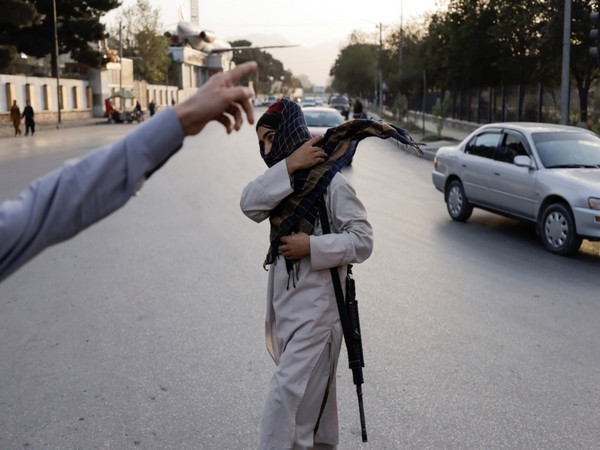 An armed member of Taliban forces walks at a check point in Kabul. (Image credit: Reuters)