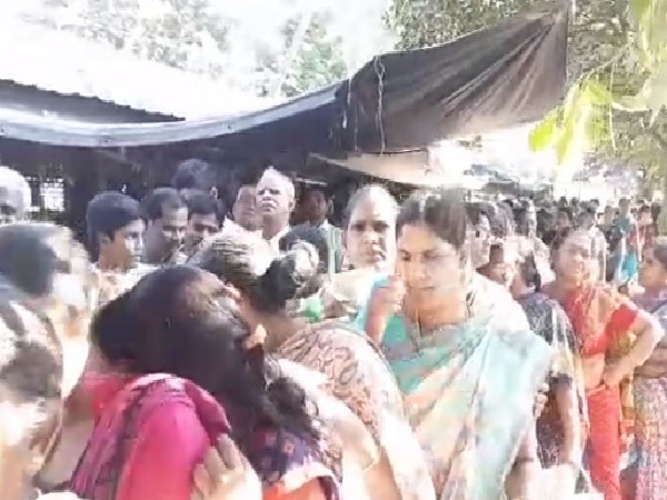 People queue up in lines to buy onions at subsidized rate in West Godavari, Andhra Pradesh on Sunday. 
