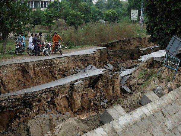 People on bikes gather near a damaged road after an earthquake in Mirpur on Wednesday. Photo/ANI