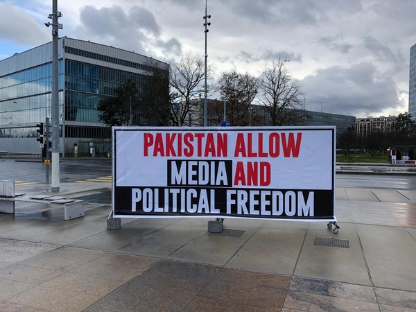 The banner bearing slogan 'Pakistan allow media and political freedom' displayed outside UN office in Geneva.