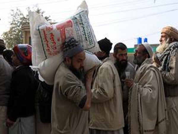 People queue up to purchase wheat flour in Pakistan