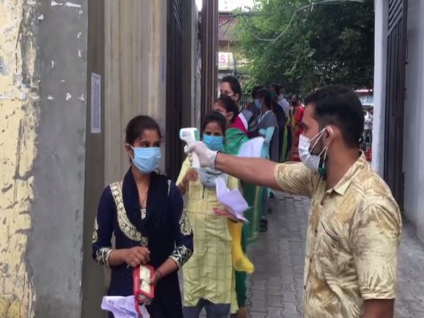 Candidates appearing for B.Ed entrance Examination undergoing thermal screening in Moradabad. (Photo/ANI)
