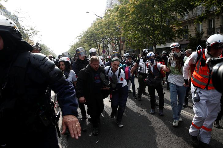 An injured French CRS riot policeman is evacuated by street medics during clashes with protesters in Paris on Wednesday (Photo: Reuters)