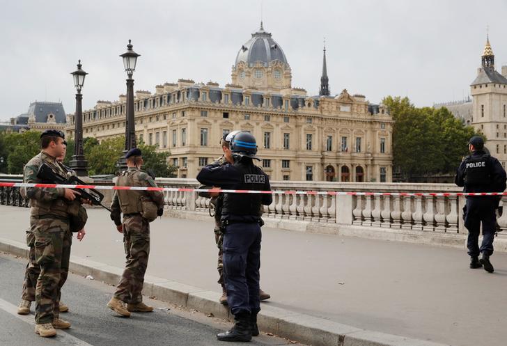 Officials outside the police headquarters in Paris on Thursday