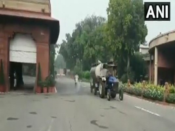 Sanitisation work being done outside Parliament ahead of monsoon session. [Photo/ANI]