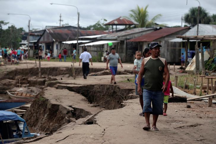 Residents walk in an area affected by a quake in Puerto Santa Gema, on the outskirts of Yurimaguas, in the Amazon region, Peru on Sunday. (Photo courtesy: Reuters)