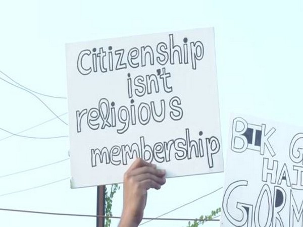 A protester displays a placard during an anti-CAA protest in Bhubaneswar on Thursday. Photo/ANI