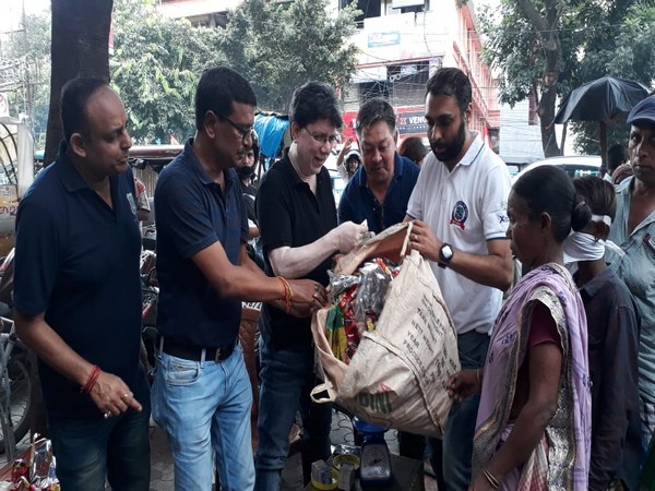 People queue up to get food in exchange of plastic waste at Siliguri on Saturday.