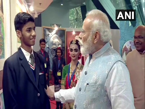 PM Modi speaking to a student at the exhibition in New Delhi on Monday. Photo/ANI