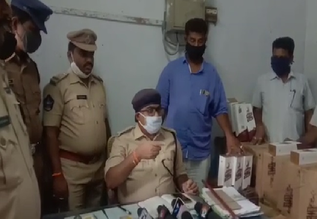 Excise department police with seized liquor in Prakasam, Andhra Pradesh. 