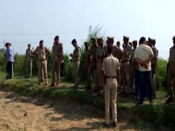 UP Police team on the field where dead bodies were recovered. (Photo/ANI)