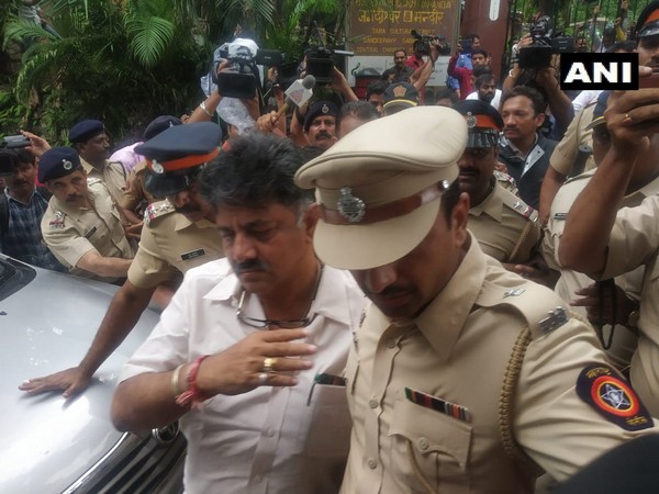 Police escort Karnataka Minister DK Shivakumar away from the gates of Renaissance - Mumbai Convention Centre Hotel where 10 rebel Congress-JD(S) MLAs are staying.