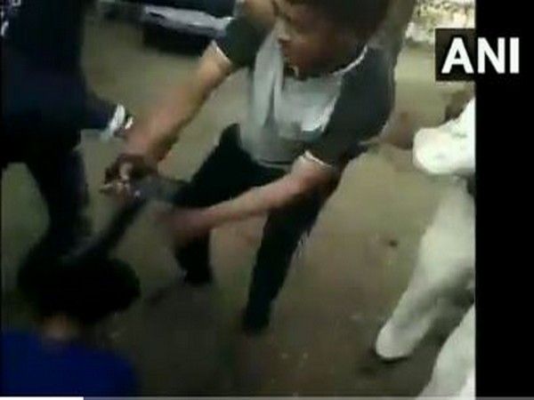 A grab of the video where Gandhwani Police Station in-charge Narendra Suryavanshi is assaulting his wife in Dhar district on Tuesday.