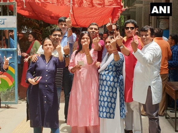 Voters outside a polling booth in Delhi on Sunday. Photo/ANI